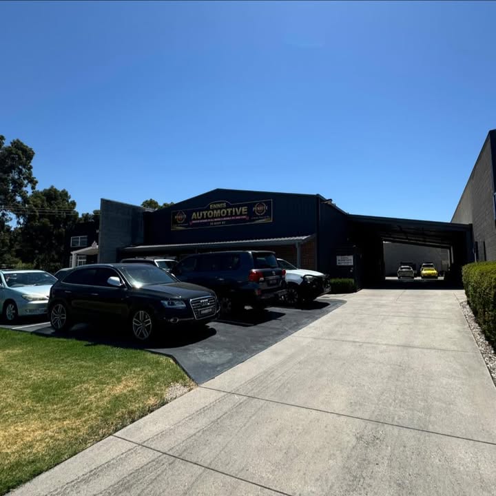 The front of the Ennis Automotive workshop with customer cars parked outside