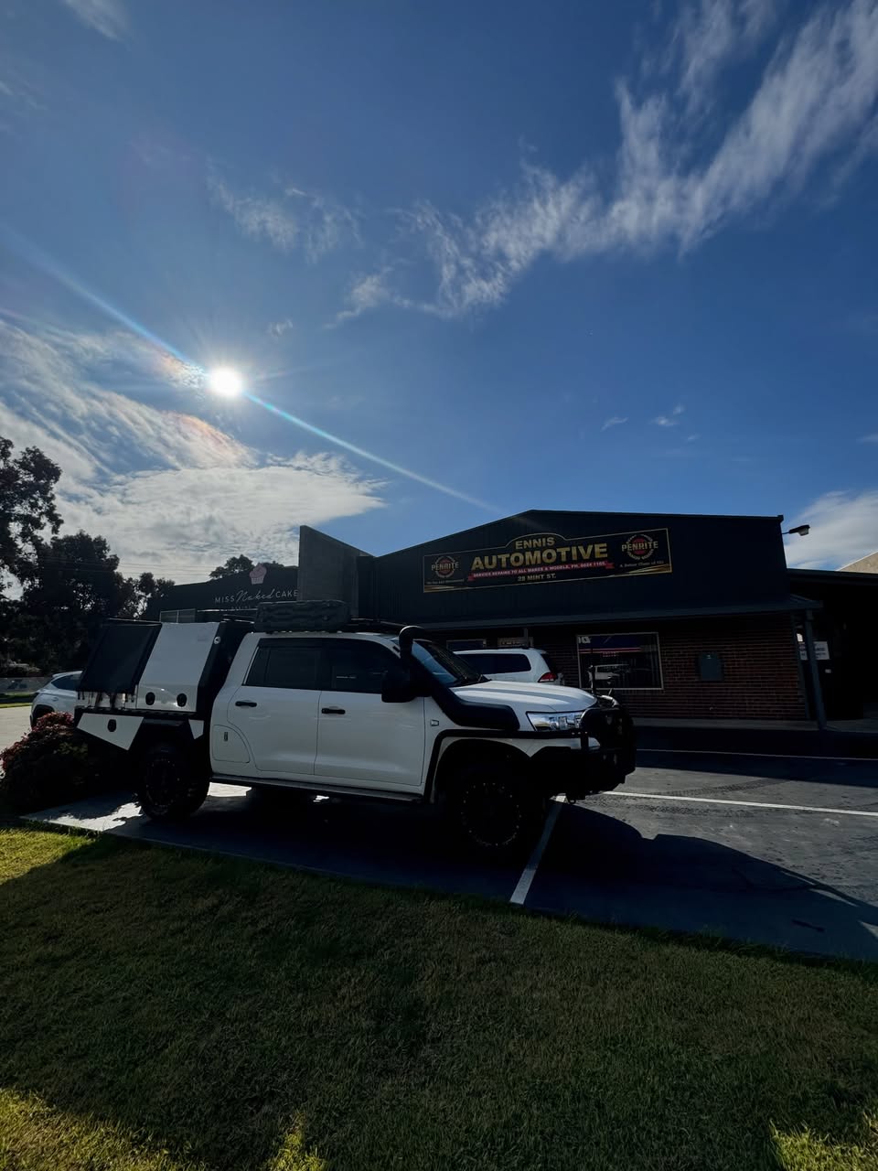 The Ennis Automotive shopfront on Mint Street, Wodonga, with a four wheel drive parked out the front