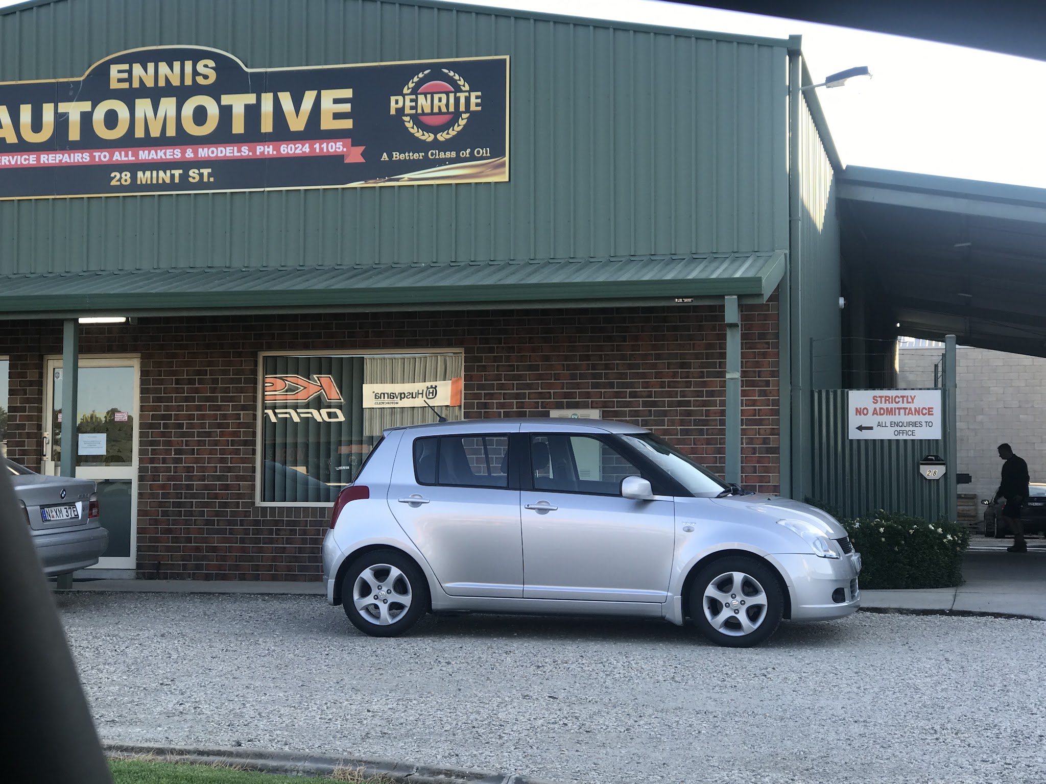 The Ennis Automotive sign at 28 Mint Street, reading service repairs to all makes and models
